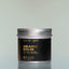 A container of Bold Fortune Beard Balm against a grey background.