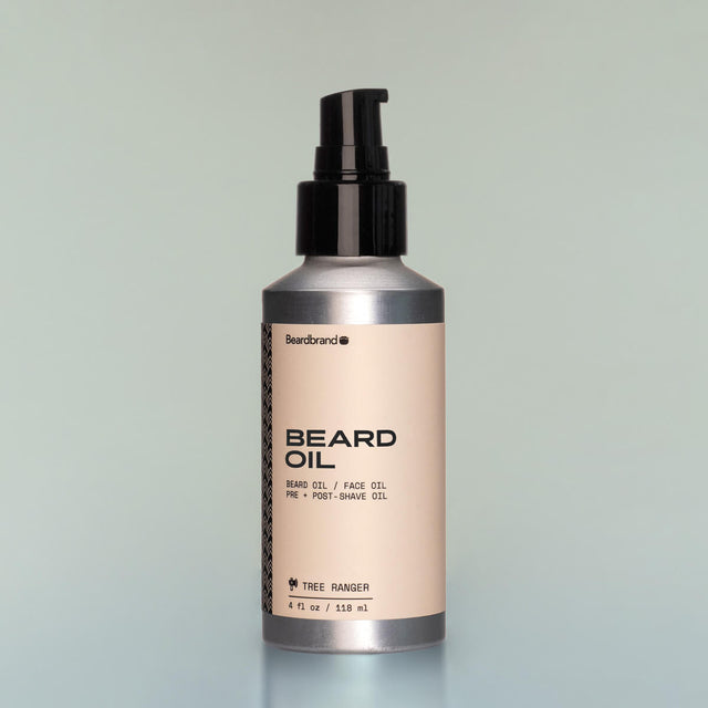 A bottle of Tree Ranger full-size Beard Oil with a pump dispenser against a grey background.
