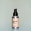 A bottle of Temple Smoke travel-size Beard Oil with a pump dispenser against a grey background.