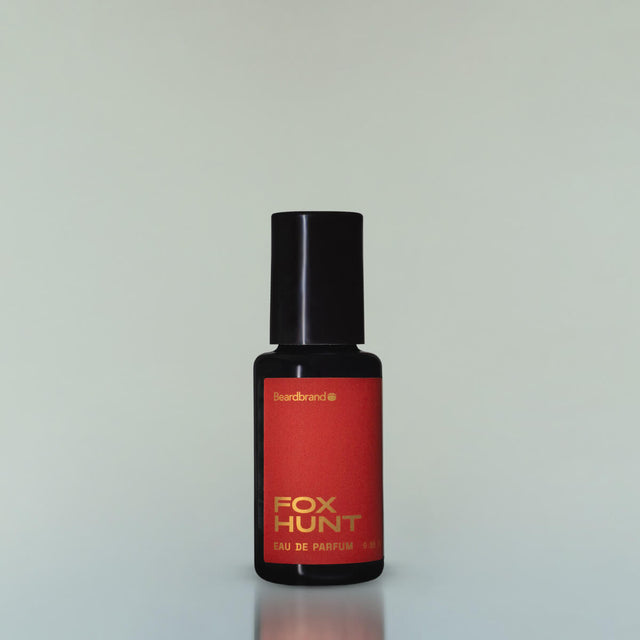 A bottle of Fox Hunt Eau de Parfum against a grey background.